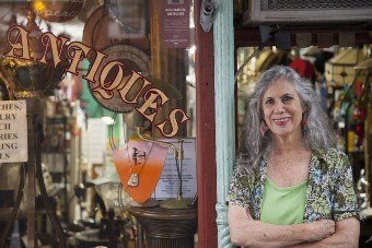 local business owner in front of her antique store